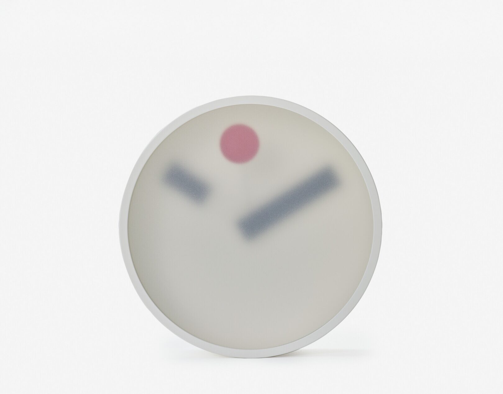 A clock with a frosted translucent layer in front of the face showing blurred clock hands and a red dot for the seconds hand