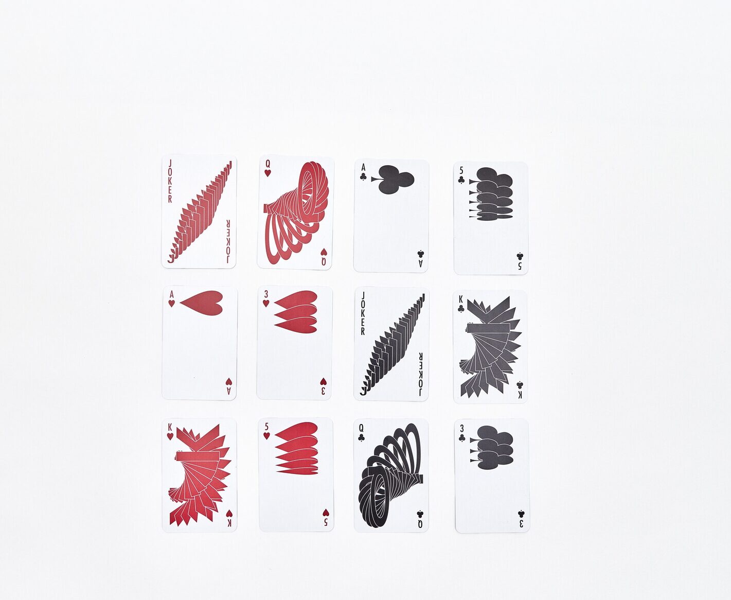 Twelve playing cards laid out, with six having a graphic red pattern and the other six having a graphic black pattern