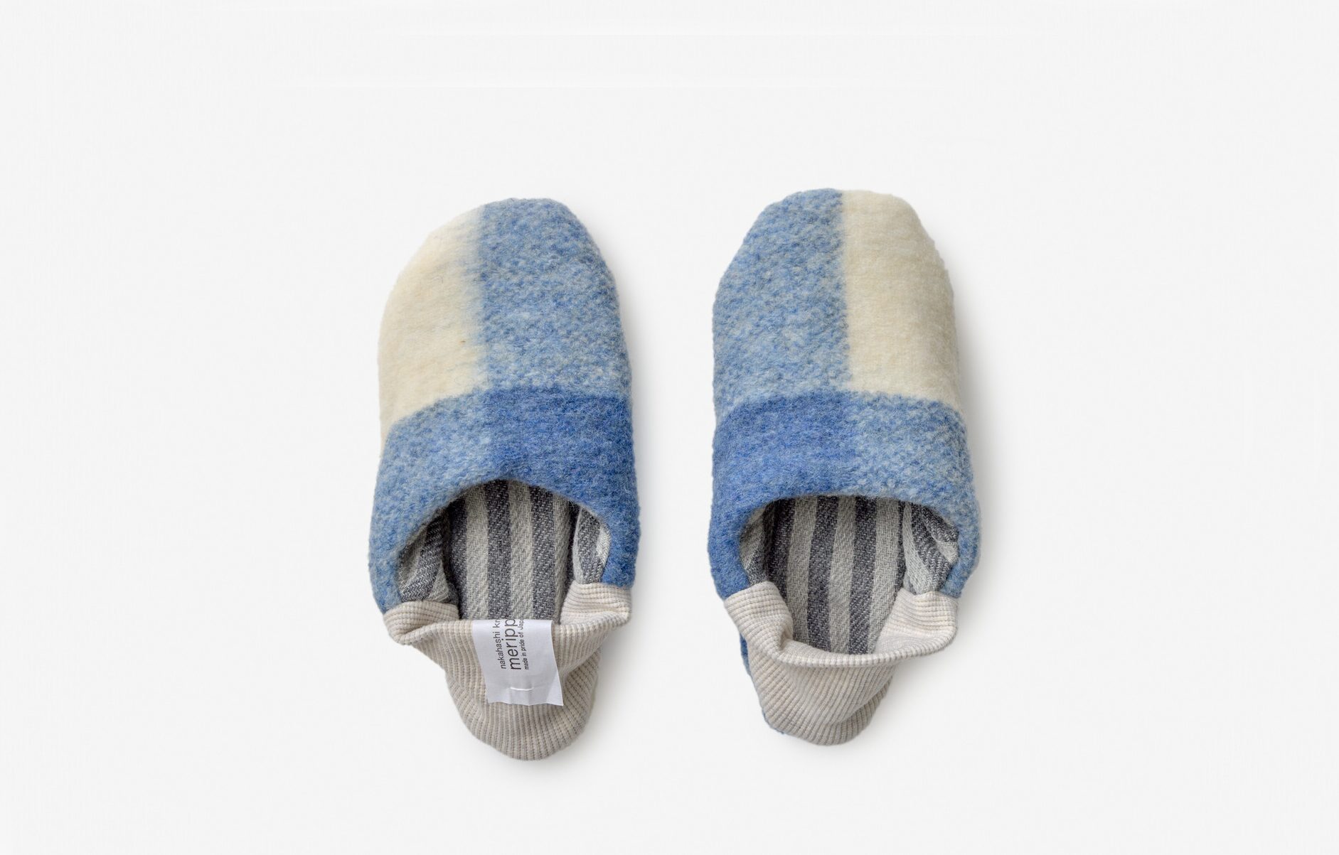 A blue and cream chequered woollen slippers with grey striped lining