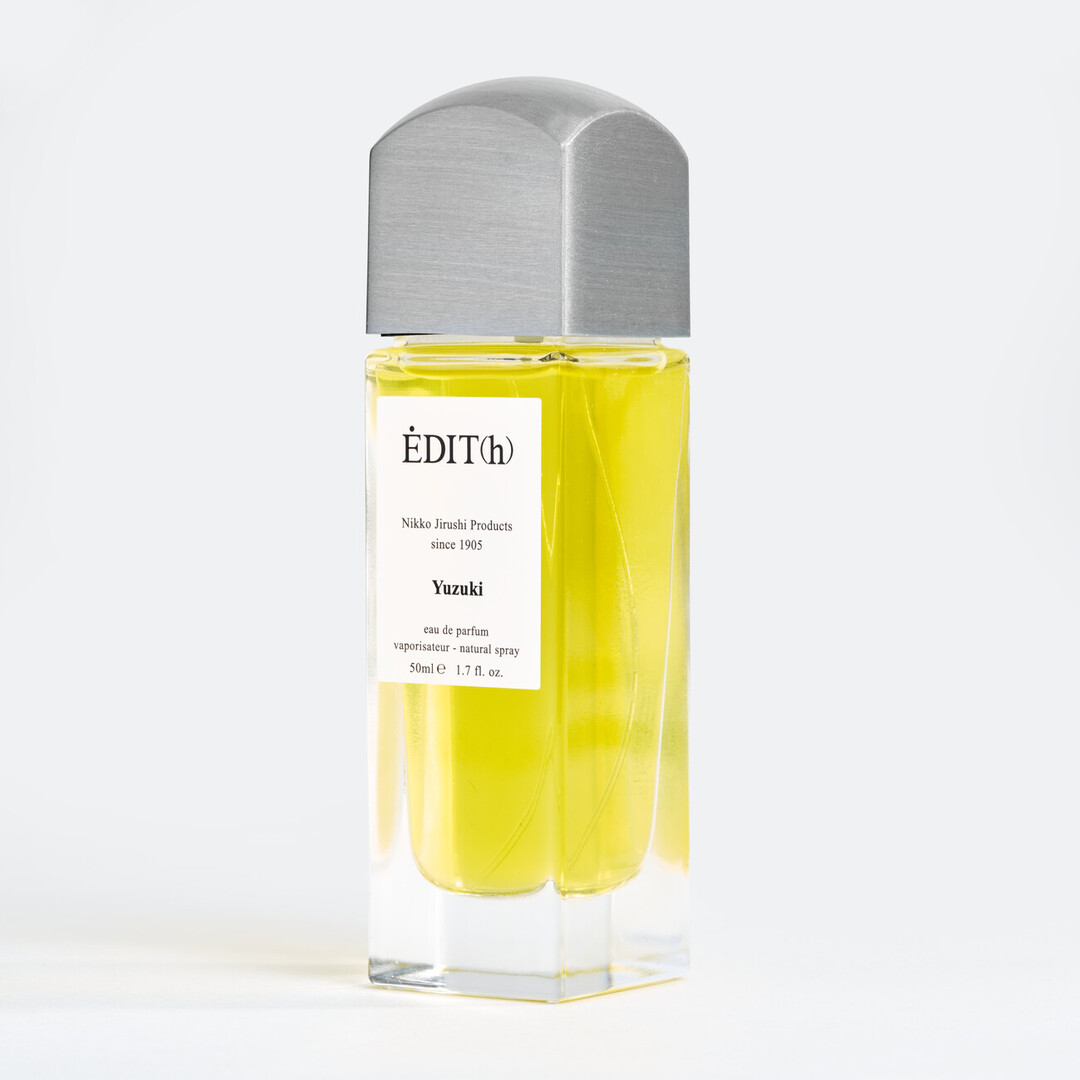 A tall rectangular perfume with a metal lid with EDIT(h) Nikko Jirushi Products since 1905 YUZUKI on the label