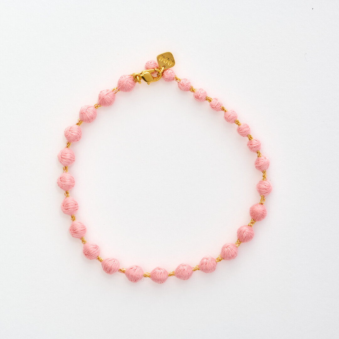 A light pink textile bracelet