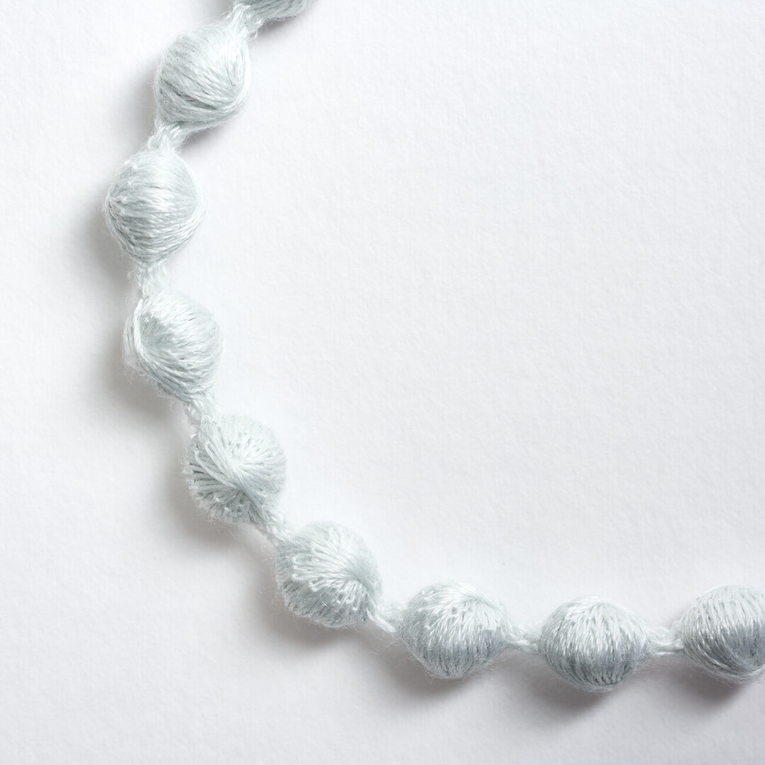 A light blue textile bracelet