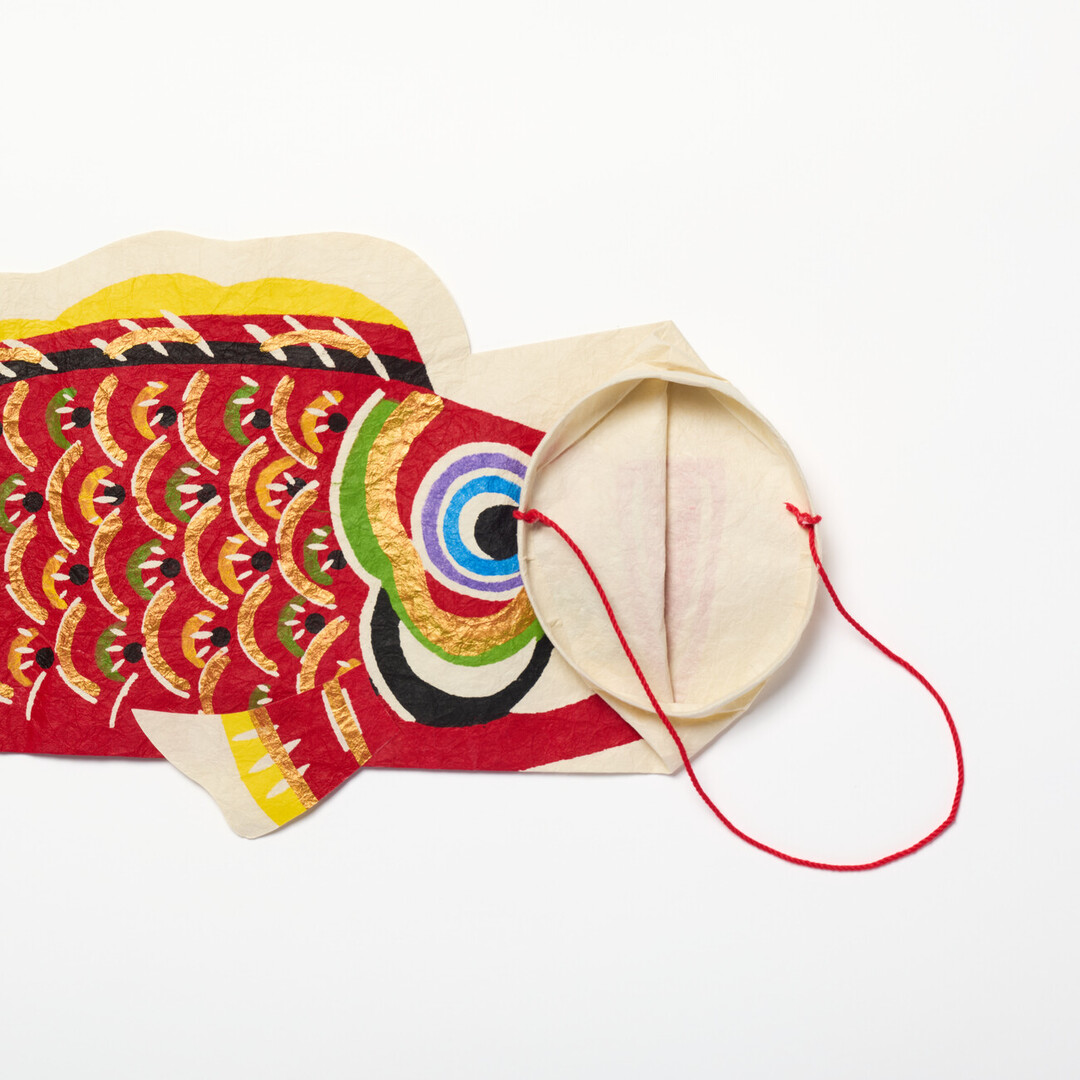 A red washi koinobori with a folded opening