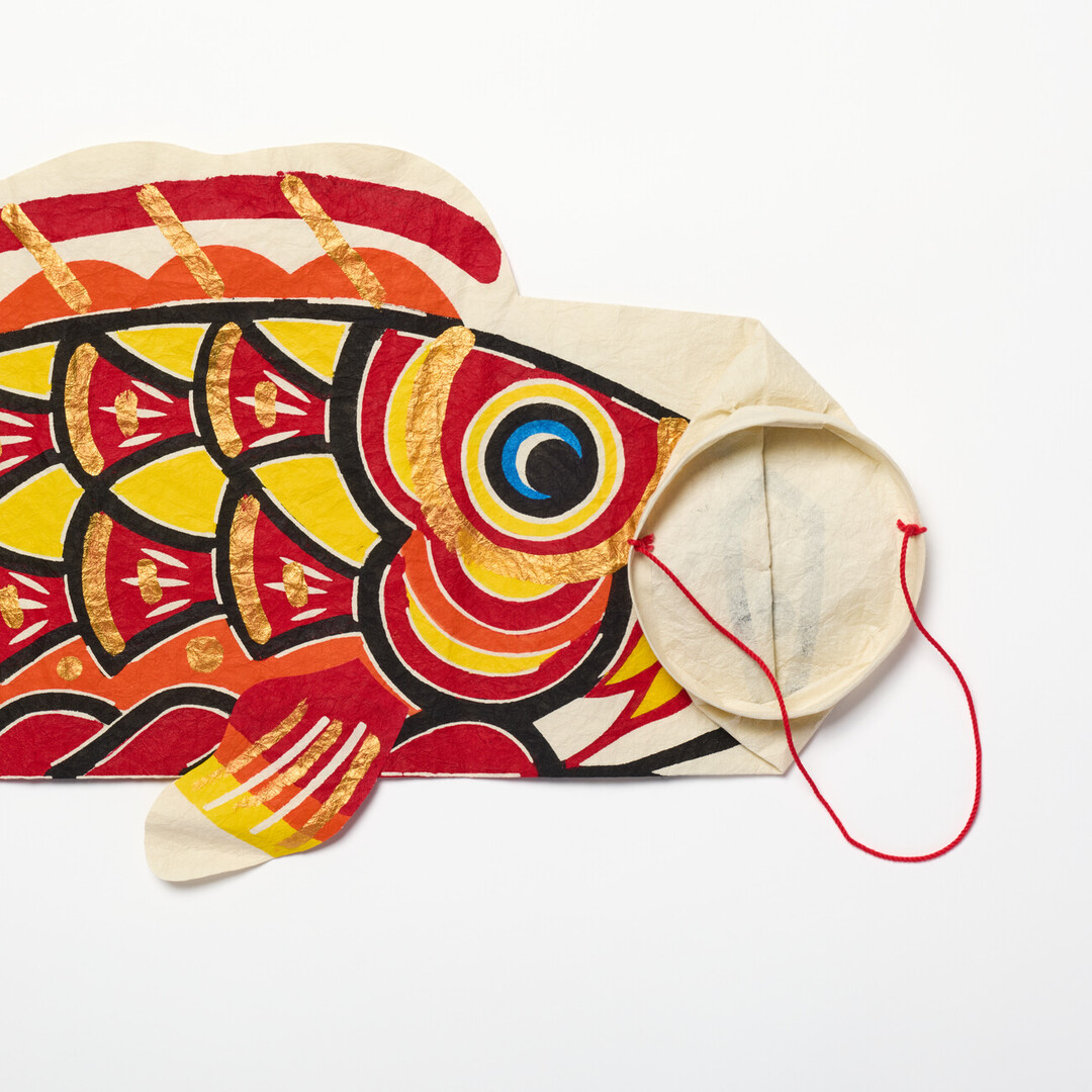 A red washi koinobori with a folded opening