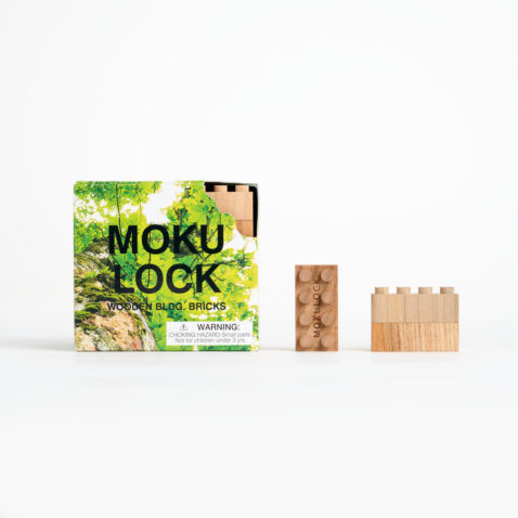 A square card packaging that says MOKU LOCK next to it, is one rectangular wooden block and next to that is two rectangular blocks on top of each other