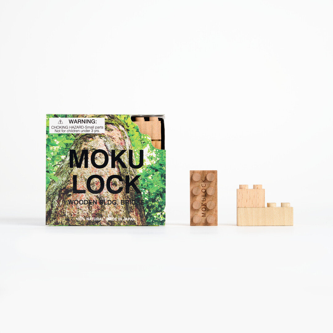 A square card packaging that says MOKU LOCK next to it, is one rectangular wooden block and next to that is one square block on top of a rectangular block