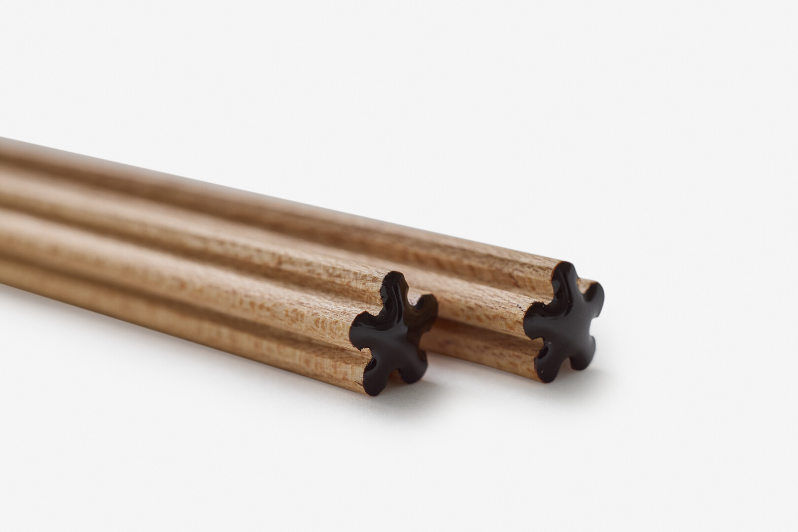 Chopsticks with brown lacquered top shaped like a flower