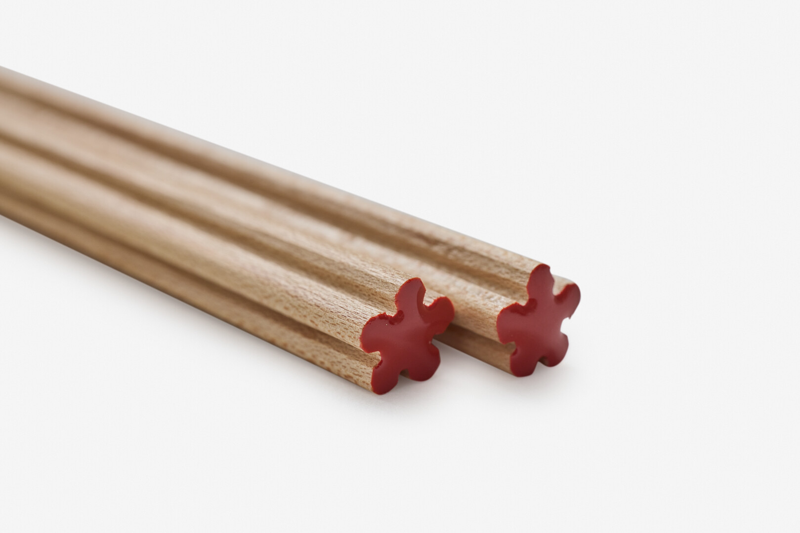 Chopsticks with red lacquered top shaped like a flower
