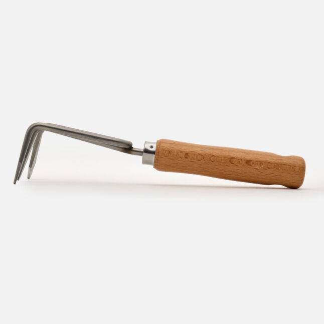 The side of the hand rake with a wooden handle
