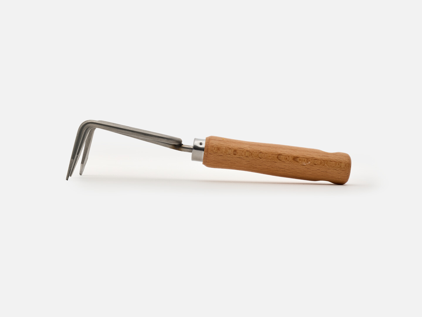 The side of the hand rake with a wooden handle