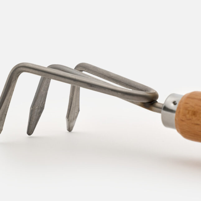 The hand rake with a wooden handle