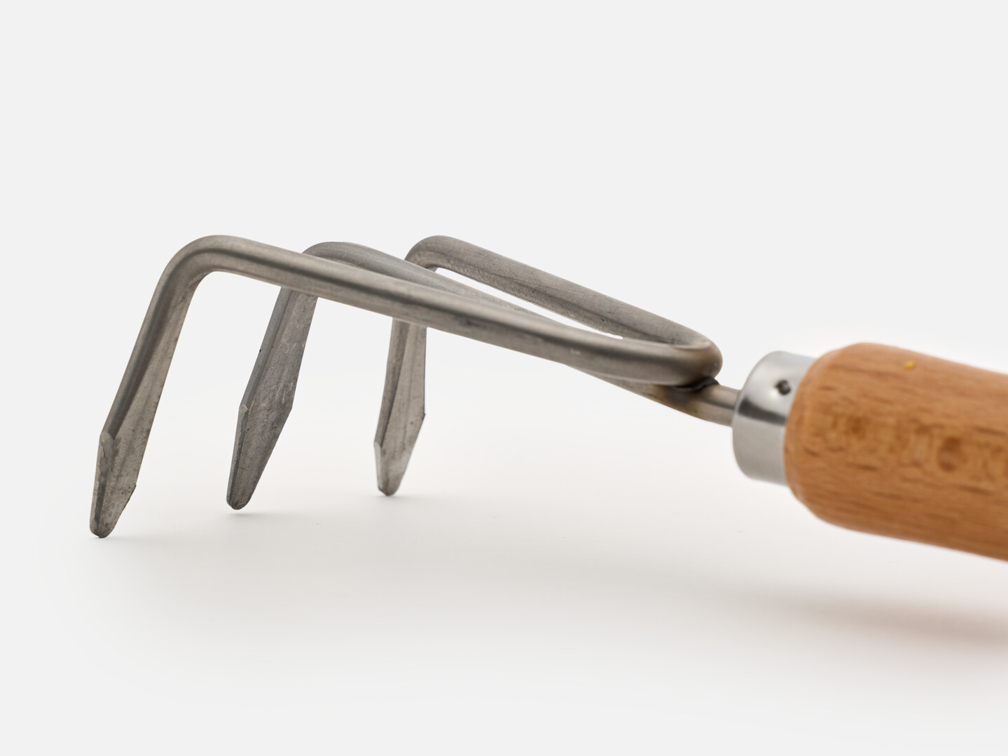 The hand rake with a wooden handle