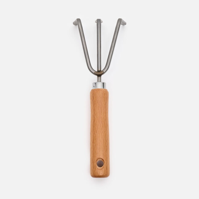 The hand rake with a wooden handle