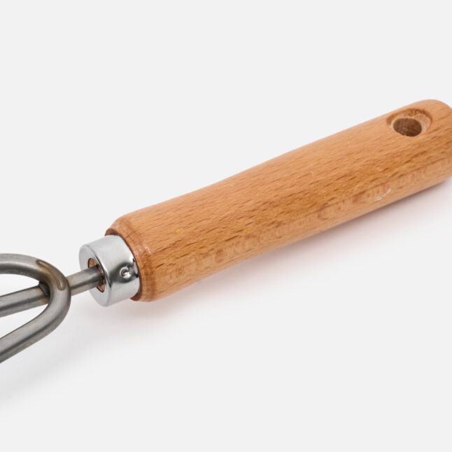 The hand rake with a wooden handle with a hole at the end
