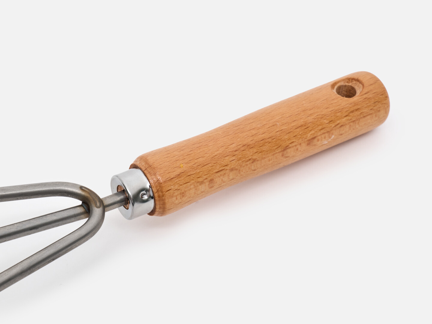 The hand rake with a wooden handle with a hole at the end