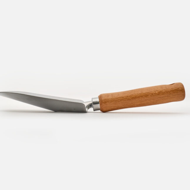 The side of a hand shovel with wooden handle