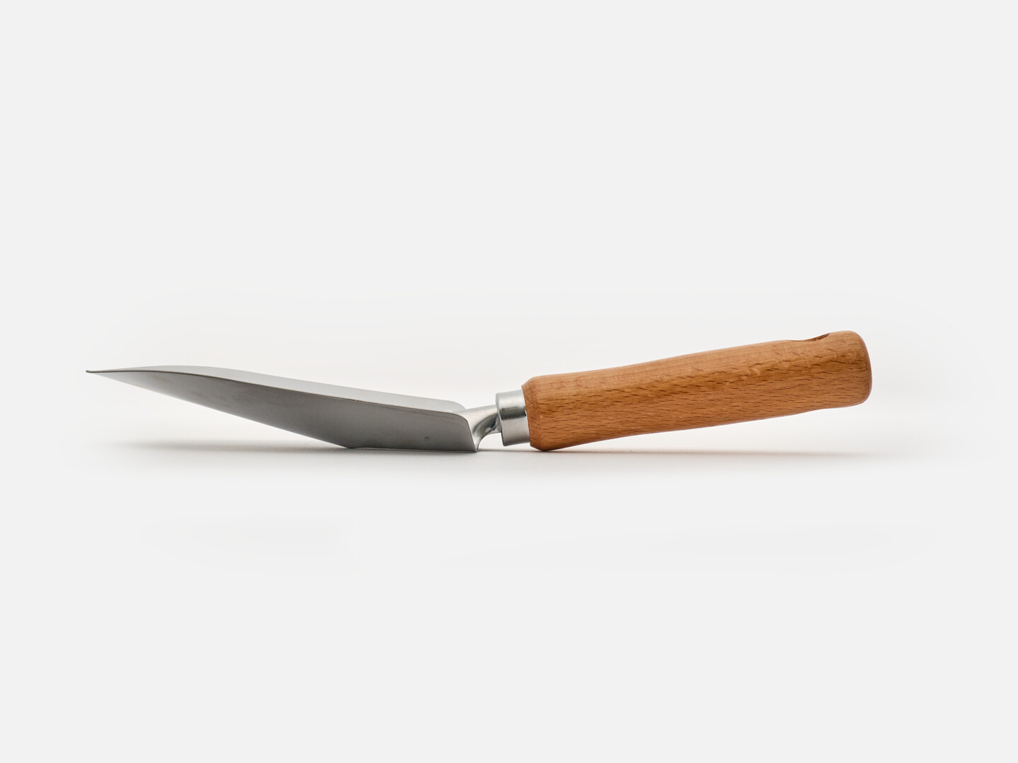 The side of a hand shovel with wooden handle