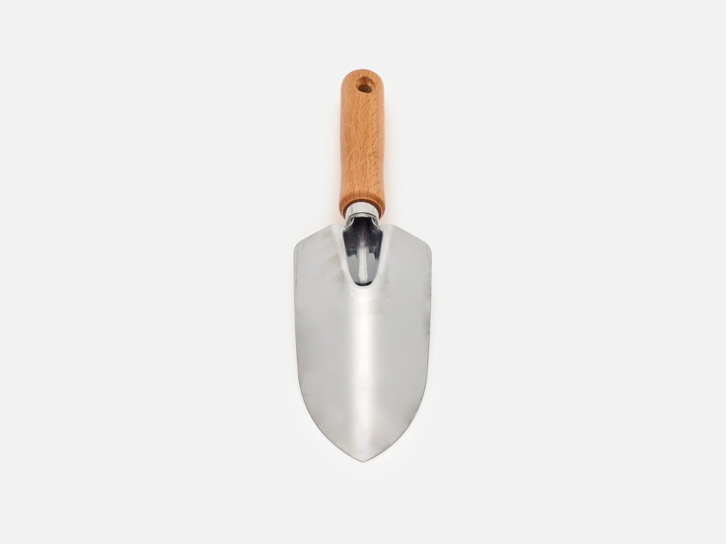 The back of a hand shovel with wooden handle