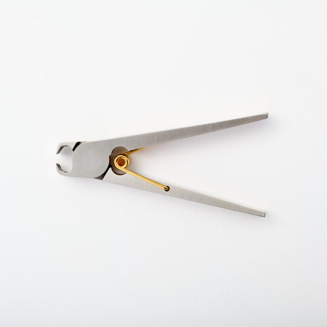 Nail clippers inspired by a clothing peg with a gold spring