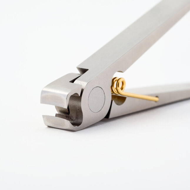 Nail clippers inspired by a clothing peg with a gold spring