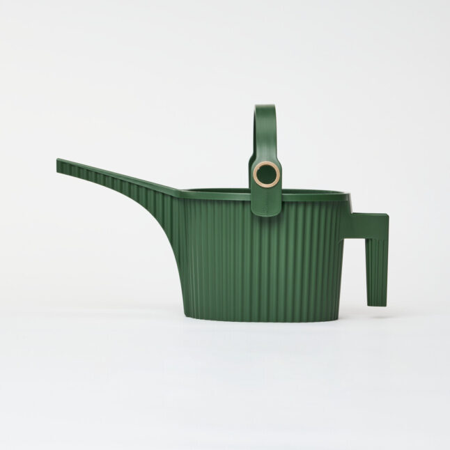 A dark green watering can with handle on the body and another arching over with a gold hole for the hose to fill with water.