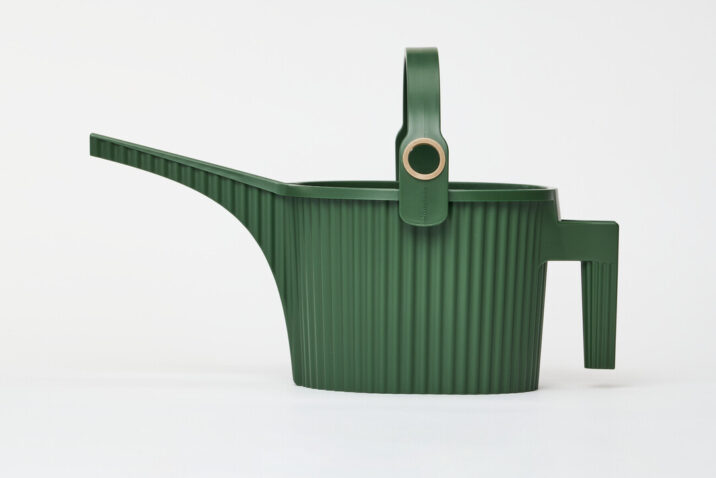 A dark green watering can with handle on the body and another arching over with a gold hole for the hose to fill with water.