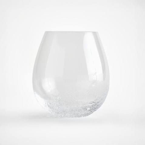 A glass with a detail on the bottom which resembles ice