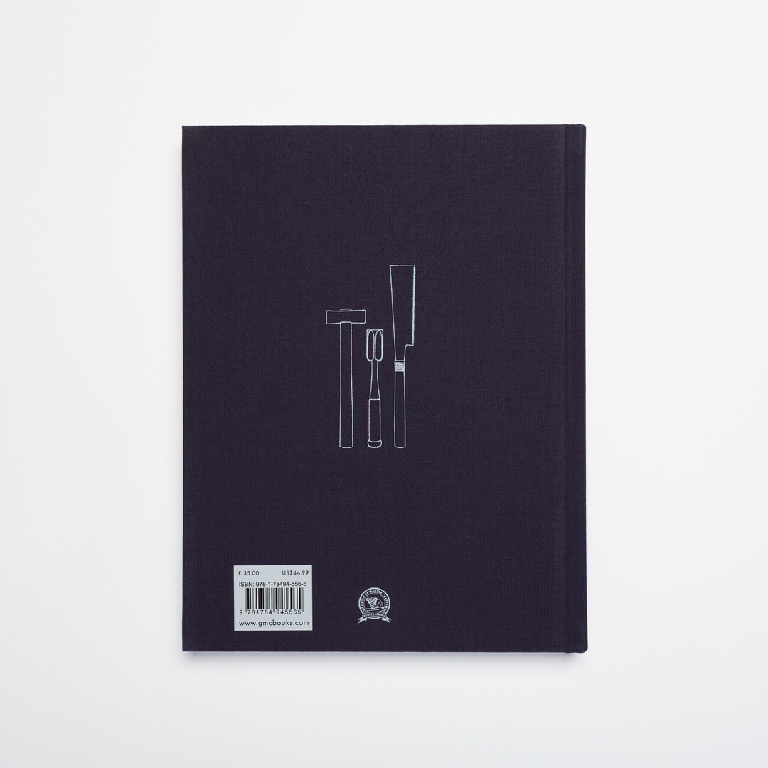 The back of a navy blue book with illustrations of wood working tools in white