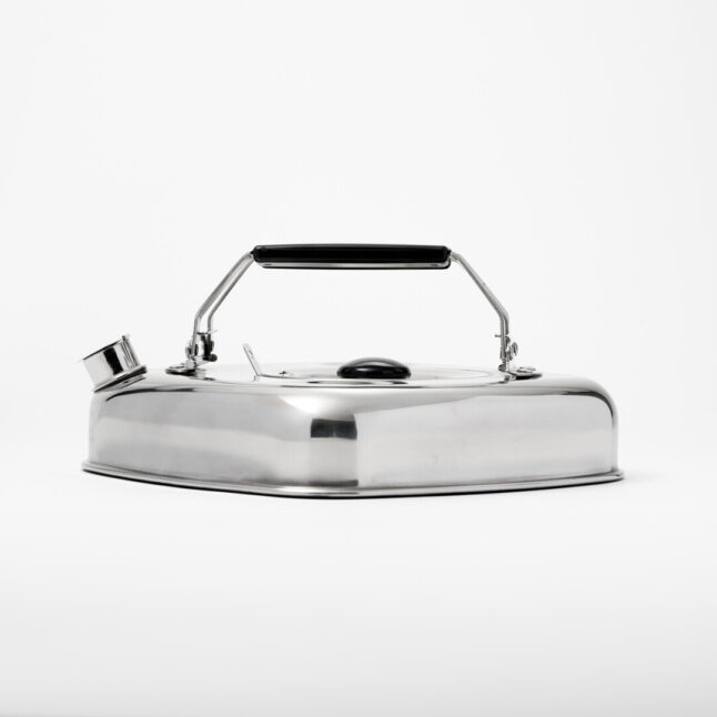 A flat square silver stove kettle with black folding handles