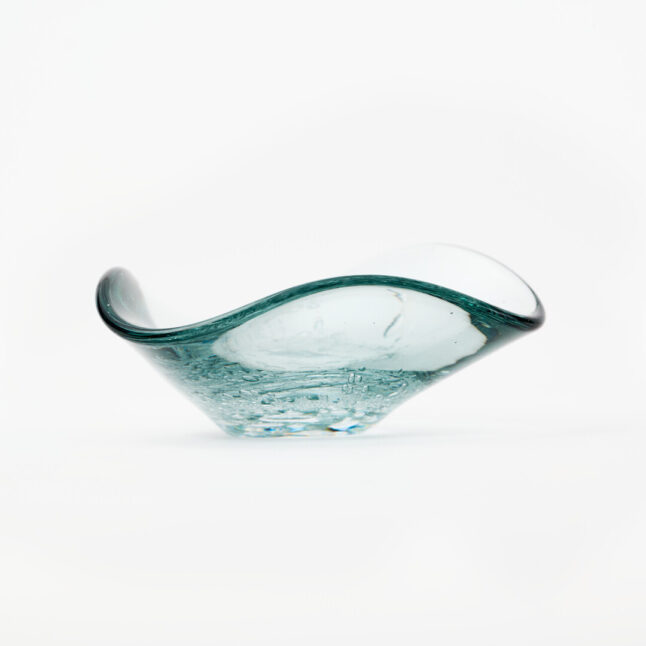 A small triangle shaped glass plate with small bubble details in the middle