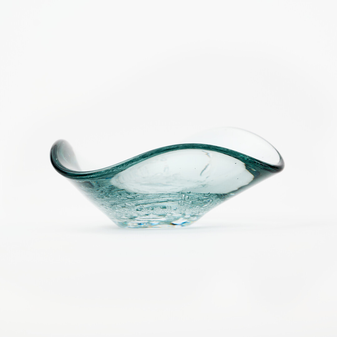 A small triangle shaped glass plate with small bubble details in the middle