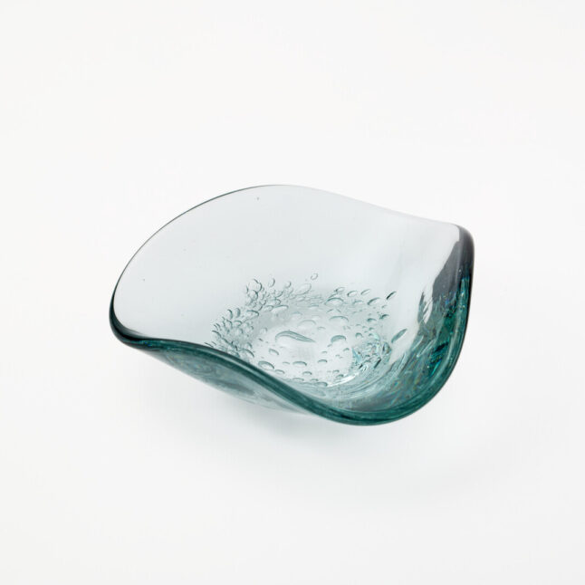 A small triangle shaped glass plate with small bubble details in the middle