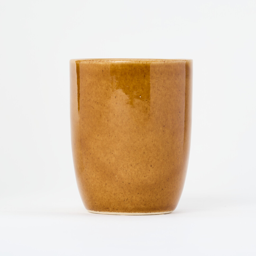A small, tall, ceramic, light brown yunomi, a cup for drinking tea
