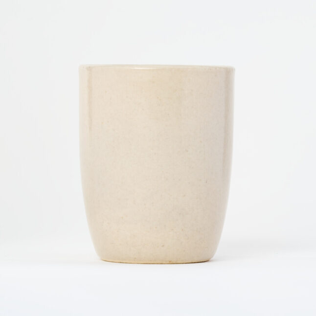 A small, tall, ceramic, white yunomi, a cup for drinking tea