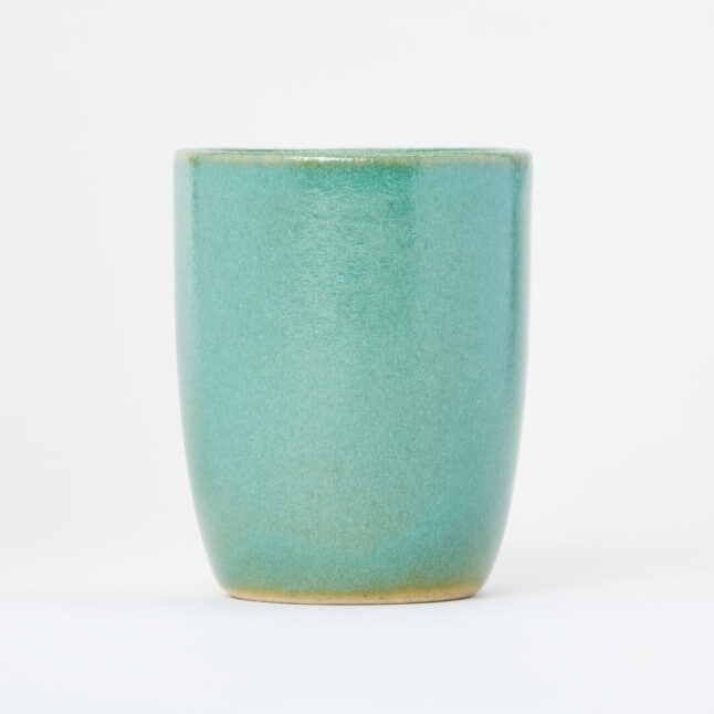 A small, tall, ceramic, light turquoise yunomi, a cup for drinking tea