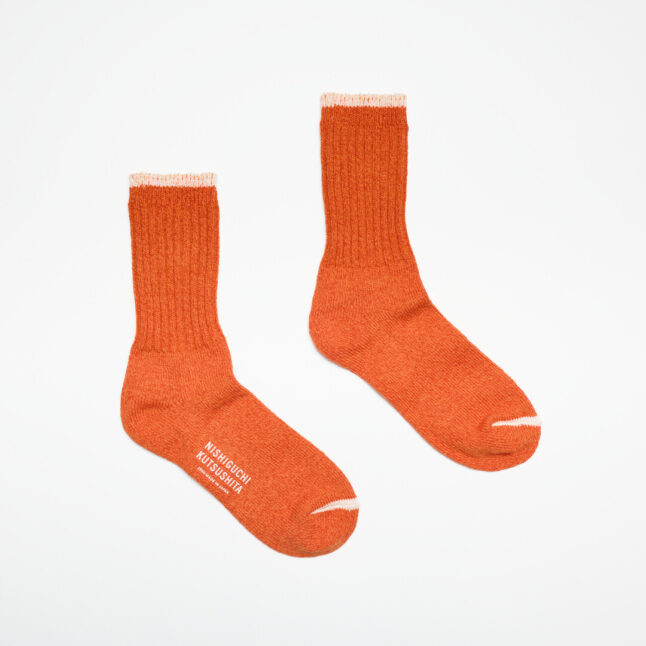 An orange sock with cream edge