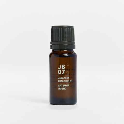 Small bottle of essential oil with white writing of JB07 Japanese Botanical Air Satsuma Hosho