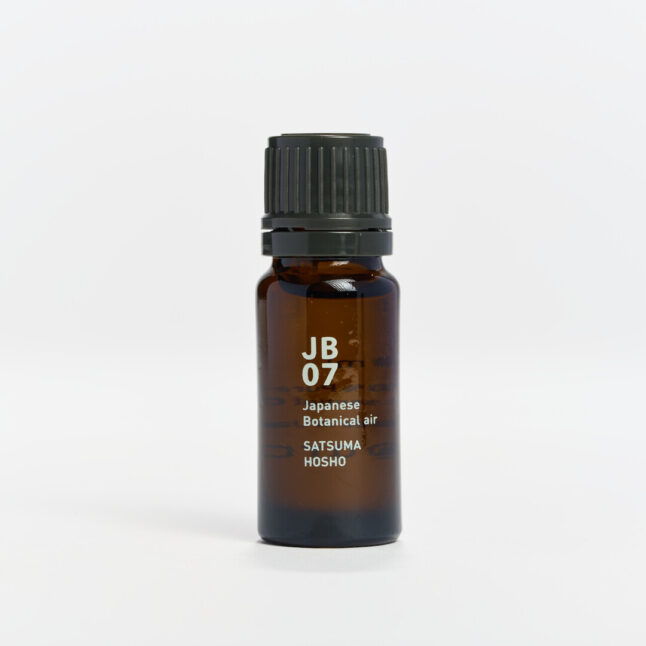 Small bottle of essential oil with white writing of JB07 Japanese Botanical Air Satsuma Hosho