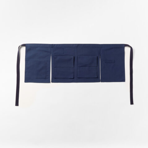 The front of the navy hannoren apron with pockets and straps for tools