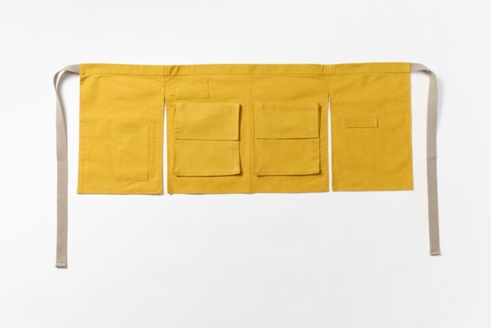 The front of the yellow hannoren apron with pockets and straps for tools