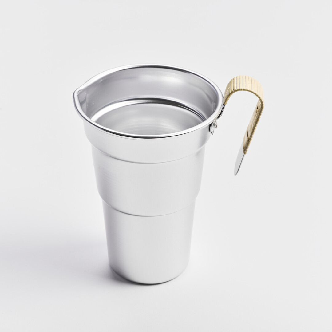 An aluminium sake pitcher with a bamboo wrapped handle