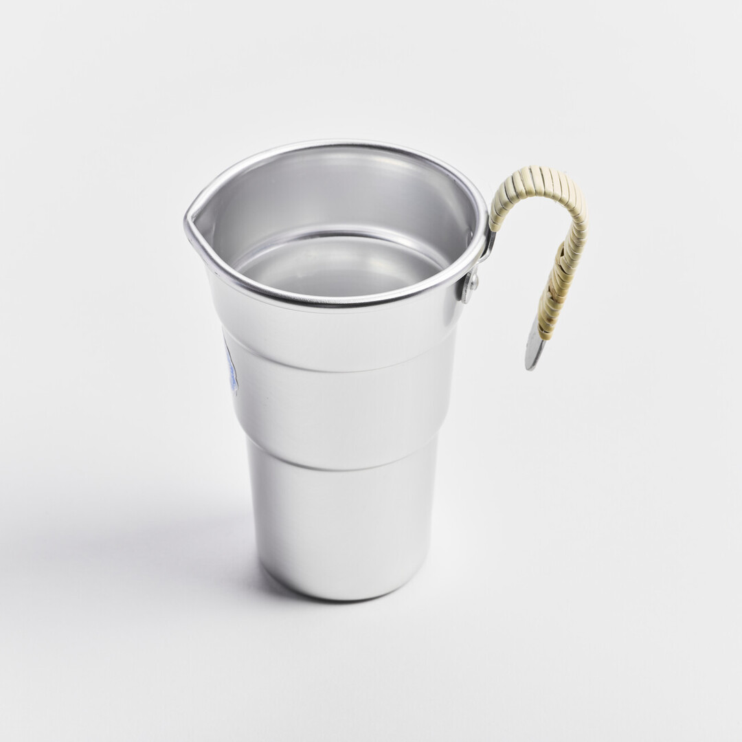 An aluminium sake pitcher with a bamboo wrapped handle