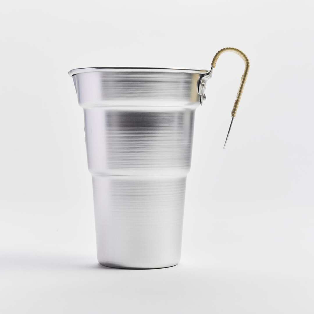 An aluminium sake pitcher with a bamboo wrapped handle