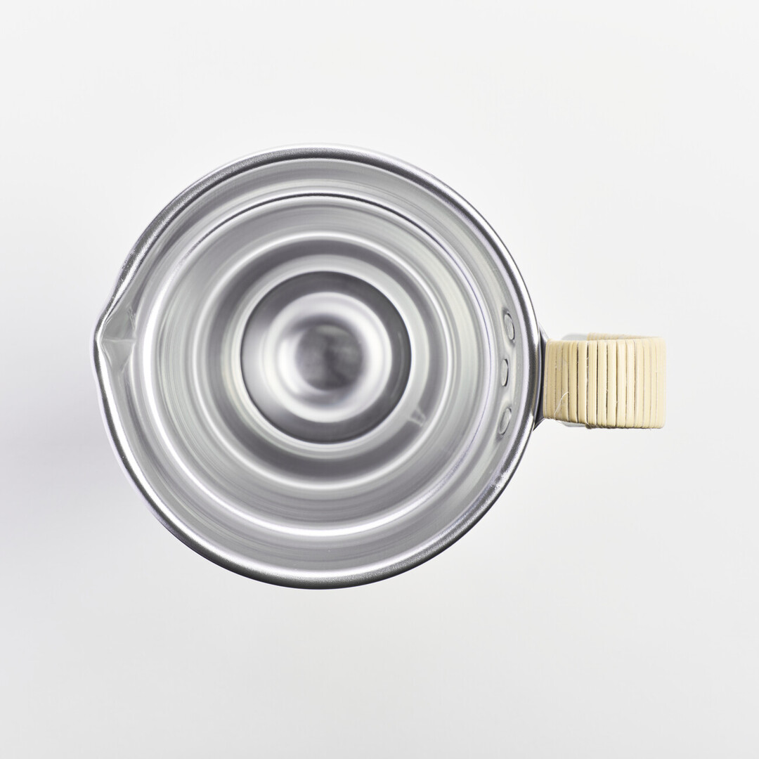 An aluminium sake pitcher with a bamboo wrapped handle