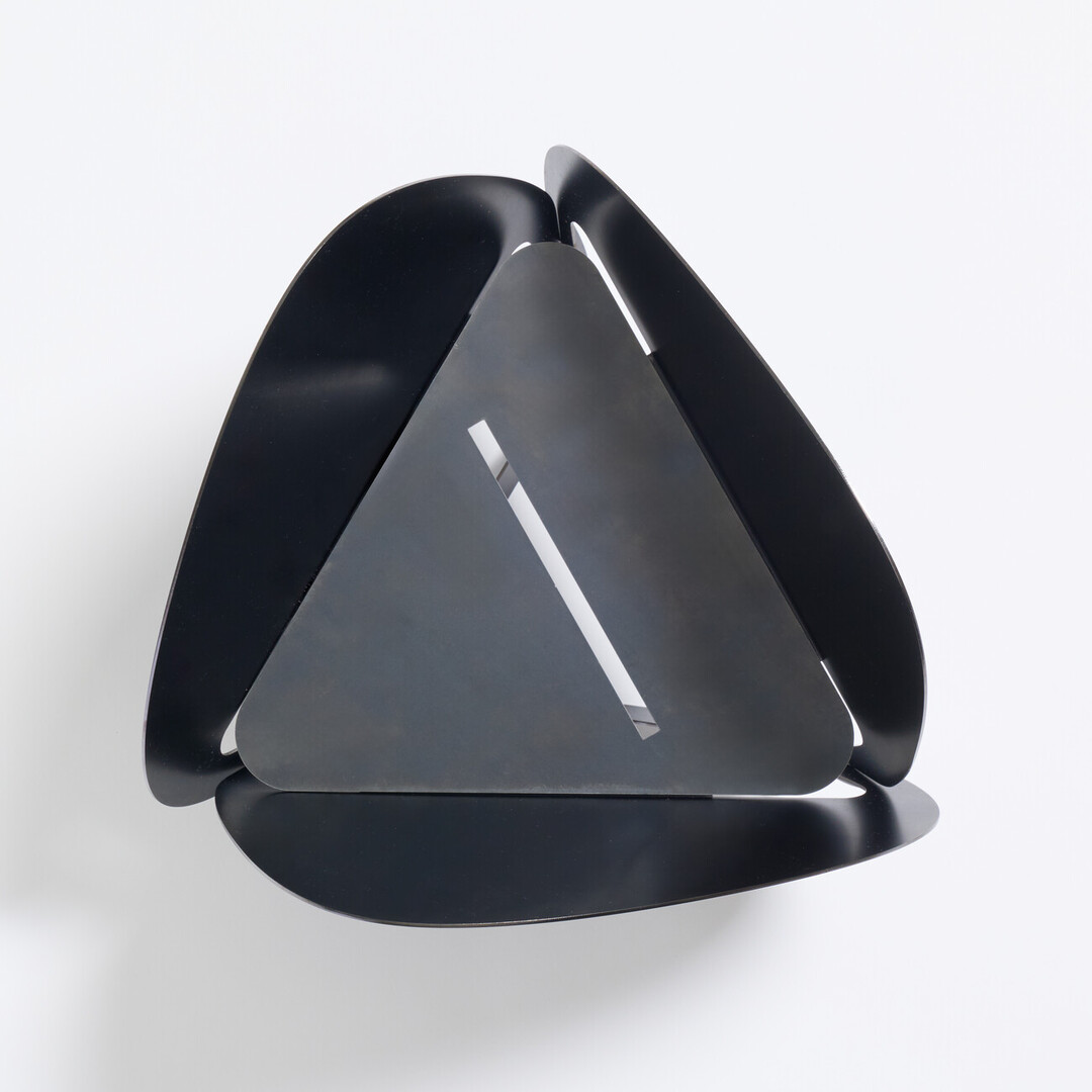 A black laser cut fire pit produced by PLAY METAL FIRE PLACE