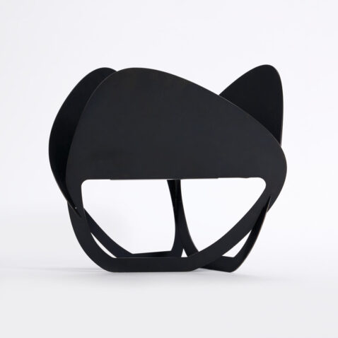 A black laser cut fire pit seen from the side produced by PLAY METAL FIRE PLACE