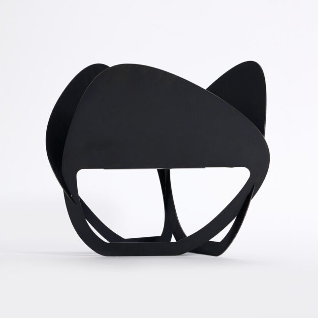 A black laser cut fire pit seen from the side produced by PLAY METAL FIRE PLACE