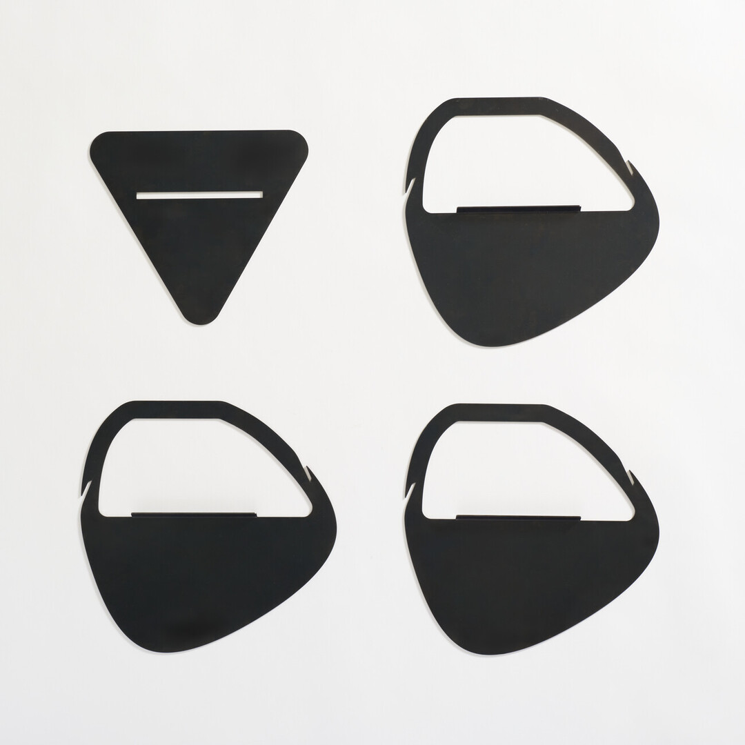 The four pieces of black laser cut fire pit produced by PLAY METAL FIRE PLACE