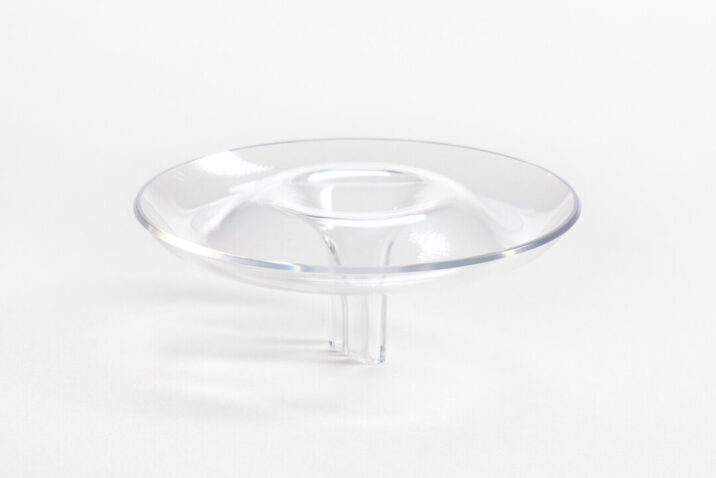 A polycarbonate flower holder that is shaped like a ripple and floats in water