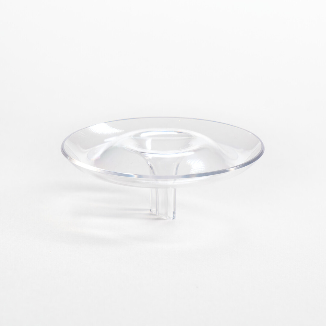 A polycarbonate flower holder that is shaped like a ripple and floats in water